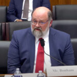 Man speaking at a conference.