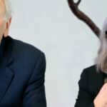 Elderly man and woman speaking at event