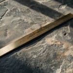 Brass straightedge on slate, representing consistent ESOP valuation standards under new federal law